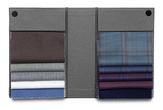 Swatch book with fabric samples in dark colors including burgundy, navy, and gray.